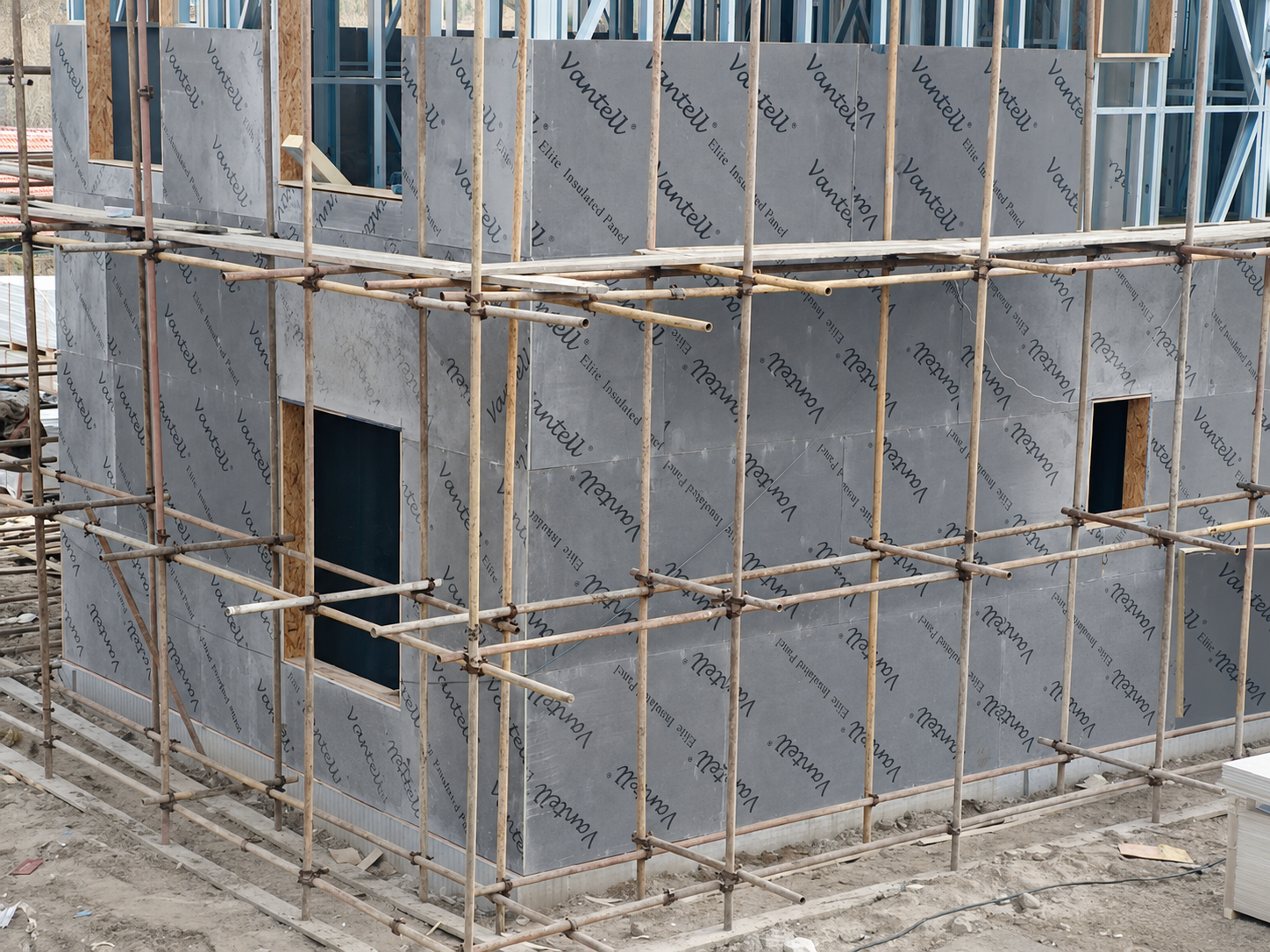 Self-adhered weather-resistive layer installed over an exterior wall panel assembly